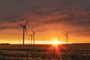 wind turbines in front of an orange sunset